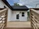 Backyard view of the new white siding, windows, glass-paned door, and wood deck at 1937 Don Juan Ln, Decatur, GA 30032