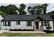 Charming renovated home featuring a gray roof, gray shutters, and a lovely front porch at 1937 Don Juan Ln, Decatur, GA 30032