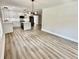 Open kitchen featuring modern lighting, white cabinets, a black island, and stainless-steel appliances at 1937 Don Juan Ln, Decatur, GA 30032
