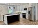 Well-lit kitchen featuring stainless steel appliances, white cabinets, and a sleek black island at 1937 Don Juan Ln, Decatur, GA 30032