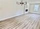 Bright living room features modern fireplace, contemporary light fixture, and wood-look flooring at 1937 Don Juan Ln, Decatur, GA 30032
