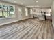 Open-concept living room featuring modern flooring and an updated kitchen with an island at 1937 Don Juan Ln, Decatur, GA 30032