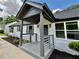Welcoming front porch showcasing gray railings, modern lighting, and freshly landscaped garden with painted brick at 1937 Don Juan Ln, Decatur, GA 30032