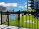 Fenced dog park area with artificial turf, paw print markings, and building views at 400 W Peachtree Nw St # 3216, Atlanta, GA 30308