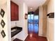 Bright hallway with hardwood floors and modern fixtures leading to a balcony with city views at 400 W Peachtree Nw St # 3216, Atlanta, GA 30308
