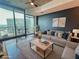 Bright, modern living room with a large sliding glass door leading to a balcony with city views at 400 W Peachtree Nw St # 3216, Atlanta, GA 30308