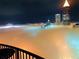 Striking night view with fog rolling in, creating a dreamy cityscape illuminated below at 400 W Peachtree Nw St # 3216, Atlanta, GA 30308