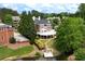 Back of brick house featuring a spacious deck, lush lawn, pond access, and gazebo at 5070 Riverlake Dr, Peachtree Corners, GA 30097