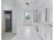 Bright bathroom showcasing a soaking tub, custom cabinets, double sinks, and a glass-enclosed shower at 5070 Riverlake Dr, Peachtree Corners, GA 30097