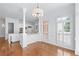 Bright, white eat-in kitchen featuring hardwood floors, island with seating, and stainless steel appliances at 5070 Riverlake Dr, Peachtree Corners, GA 30097