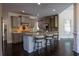 Open kitchen with center island, granite countertops, and stainless steel appliances at 610 Big Bend Trail, Sugar Hill, GA 30518