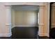 Open living space with architectural columns and dark hardwood floors at 610 Big Bend Trail, Sugar Hill, GA 30518
