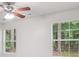 An airy bedroom with two windows bringing in natural light and a ceiling fan for comfort at 1528 Wembley Dr, Douglasville, GA 30134