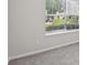 A cozy bedroom showcasing soft gray carpet and a window with nice outdoor views at 1528 Wembley Dr, Douglasville, GA 30134