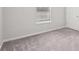 A carpeted bedroom with a window and a closet door at 1528 Wembley Dr, Douglasville, GA 30134
