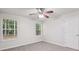 A carpeted bedroom featuring neutral walls, two windows, and a ceiling fan at 1528 Wembley Dr, Douglasville, GA 30134