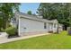 Charming single-story home featuring light gray siding, a well-kept lawn, and a cozy entrance at 1528 Wembley Dr, Douglasville, GA 30134