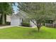 Attractive single-story home with an attached garage, surrounded by lush greenery and mature trees at 1528 Wembley Dr, Douglasville, GA 30134