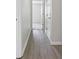 Hallway with wood floors, doors, and fresh, neutral paint at 1528 Wembley Dr, Douglasville, GA 30134