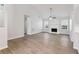 Spacious living room featuring hardwood floors, a fireplace, and large windows for natural light at 1528 Wembley Dr, Douglasville, GA 30134