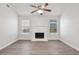 Living room with hardwood floors, fireplace, ceiling fan, and neutral paint at 1528 Wembley Dr, Douglasville, GA 30134