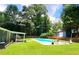 Outdoor oasis featuring a sparkling pool, a charming shed, and lush greenery for ultimate relaxation at 2913 Jordan Forest Trl, Lawrenceville, GA 30044