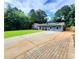 Inviting single-story home with a lush green lawn, long driveway and solar panels at 2913 Jordan Forest Trl, Lawrenceville, GA 30044