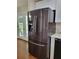 Modern kitchen featuring a stainless steel Samsung refrigerator and ample natural light from the french doors at 2913 Jordan Forest Trl, Lawrenceville, GA 30044