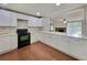 Modern kitchen with white cabinetry, sleek countertops, updated appliances, and a functional open layout at 2913 Jordan Forest Trl, Lawrenceville, GA 30044
