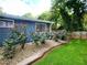 Exterior landscaping with a flowerbed containing mature rose bushes at 2913 Jordan Forest Trl, Lawrenceville, GA 30044
