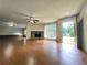 Spacious living room features a stone fireplace, natural light, and beautiful flooring, perfect for relaxation at 2913 Jordan Forest Trl, Lawrenceville, GA 30044