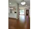 Open-concept living room featuring a large window, stone fireplace, and hardwood floors at 2913 Jordan Forest Trl, Lawrenceville, GA 30044