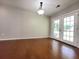 Bright living room featuring french doors, hardwood floors, and a modern light fixture at 2913 Jordan Forest Trl, Lawrenceville, GA 30044