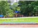 A fenced-in play area at Sweetwater Park with a colorful playground structure at 2913 Jordan Forest Trl, Lawrenceville, GA 30044