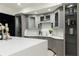 Basement bar boasts gray cabinets, a sleek countertop, and tasteful decor at 3258 Bransley Way, Duluth, GA 30097
