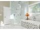Bathroom features a glass shower, modern tub with decorative accents, and natural lighting at 3258 Bransley Way, Duluth, GA 30097