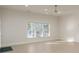 Spacious bedroom with herringbone floors, white walls, and natural light from the window at 3258 Bransley Way, Duluth, GA 30097