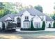 Front exterior elevation of stately white house with grey roof and well-maintained landscaping at 3258 Bransley Way, Duluth, GA 30097