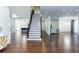 Bright and open foyer with dark hardwood floors, a staircase, and an open floorplan at 3258 Bransley Way, Duluth, GA 30097