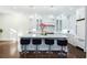 Modern kitchen featuring a large island with bar stools, stainless steel appliances, and pendant lighting at 3258 Bransley Way, Duluth, GA 30097