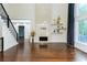 Spacious living room with a fireplace, hardwood floors, a staircase, and large windows at 3258 Bransley Way, Duluth, GA 30097