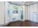 Living room features three large windows, dark hardwood floors and decorative accents at 3258 Bransley Way, Duluth, GA 30097