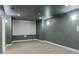 Finished gray theater room with a projection screen, wall lighting, and carpet at 3258 Bransley Way, Duluth, GA 30097