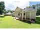 Green backyard with a large lawn, a brick patio and a home with white siding at 334 Bridgewood Se Dr, Conyers, GA 30094