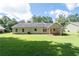 A large green backyard with covered patio at 334 Bridgewood Se Dr, Conyers, GA 30094