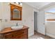 Bathroom offers a wood vanity with a large mirror and a window providing natural light at 334 Bridgewood Se Dr, Conyers, GA 30094