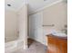 Bathroom boasts a shower-tub combo, a wooden vanity, and a tile floor for easy maintenance at 334 Bridgewood Se Dr, Conyers, GA 30094