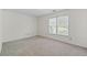 Clean bedroom with plush carpet, window and a neutral color scheme at 334 Bridgewood Se Dr, Conyers, GA 30094