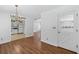 Open floorplan with hardwood floors, an elegant chandelier, and a doorway view of the kitchen at 334 Bridgewood Se Dr, Conyers, GA 30094