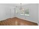 Light-filled dining room with hardwood floors, elegant chandelier, and a view of the yard at 334 Bridgewood Se Dr, Conyers, GA 30094